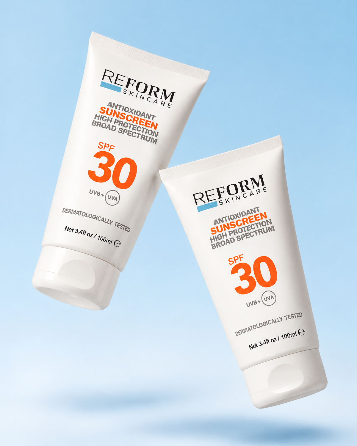 Two white tubes of Reform Skincare Antioxidant Sunscreen SPF 30, shown floating against a soft light blue gradient background.